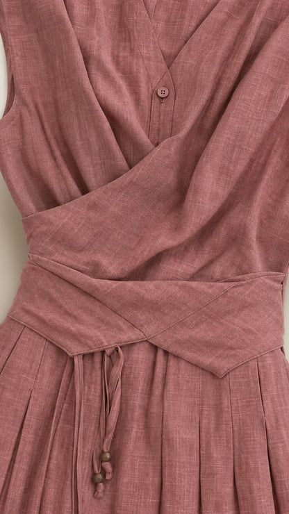 Close-up detail of crossover bodice, waist pleating, and button closure in Dusty Rose