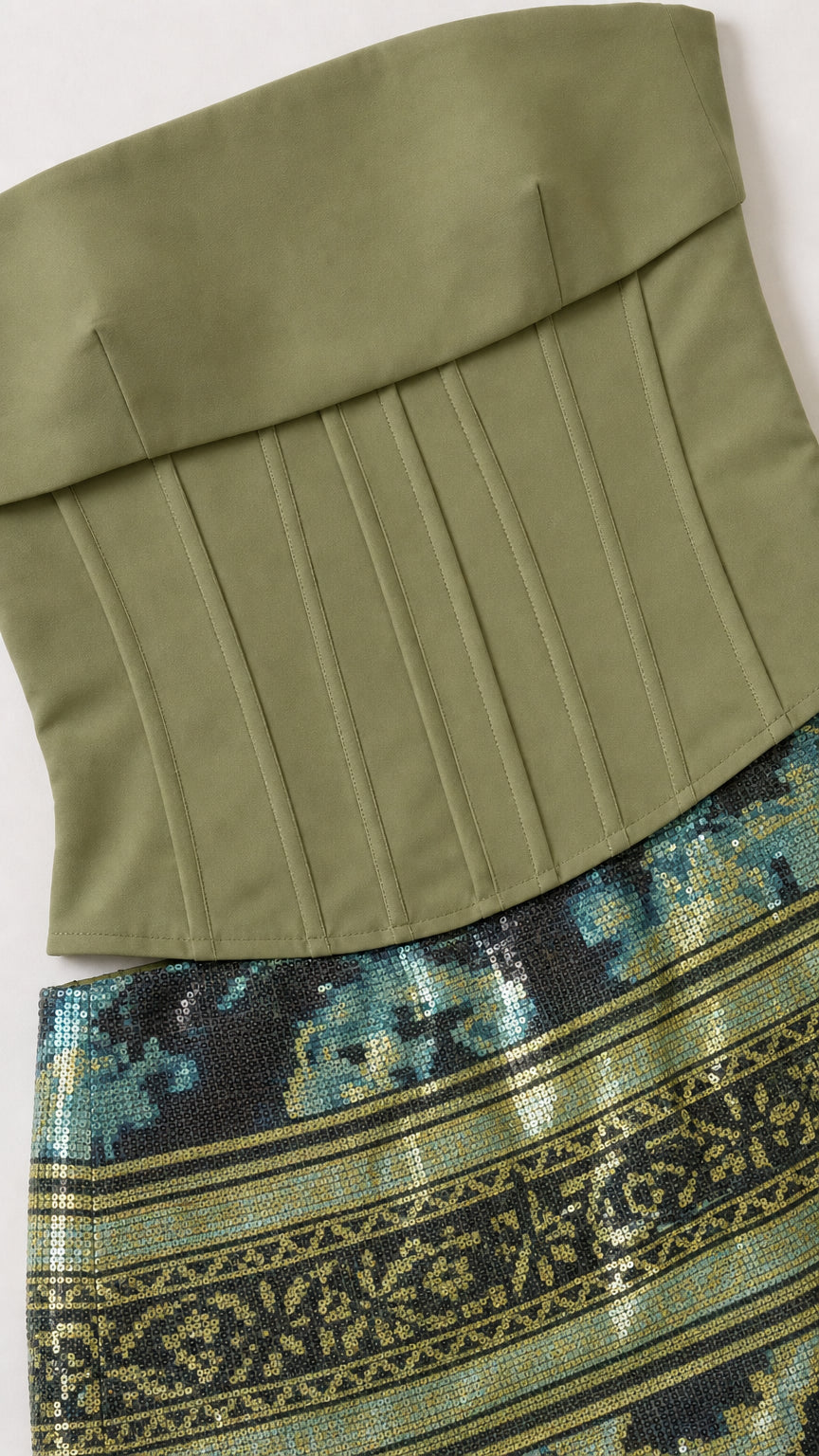 Close-up detail of sage green corset top and patterned sequin skirt