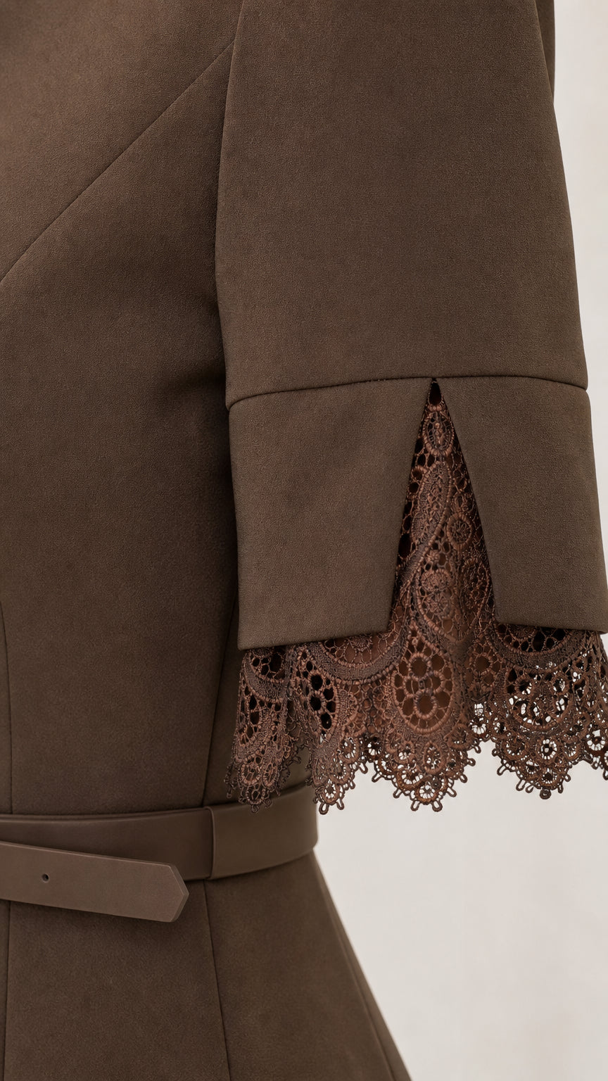 Close-up detail of split sleeve cuff with intricate floral lace trim and belt