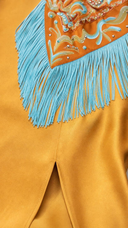 Close up of beaded embroidery and turquoise fringe on yellow satin dress
