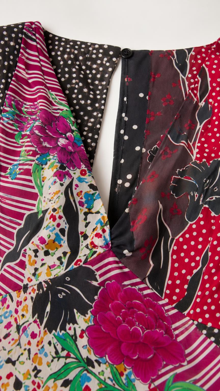 Close-up of patchwork pattern and button closure