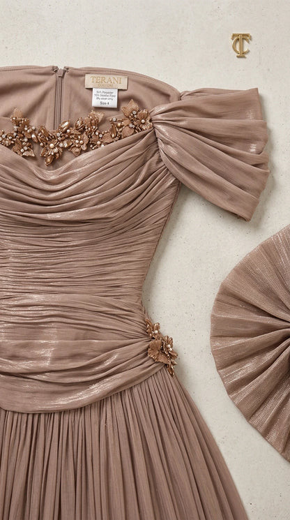 Close-up detail of beaded floral trim and ruched metallic bodice