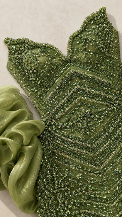 Close-up detail of geometric beadwork and organza ruffle