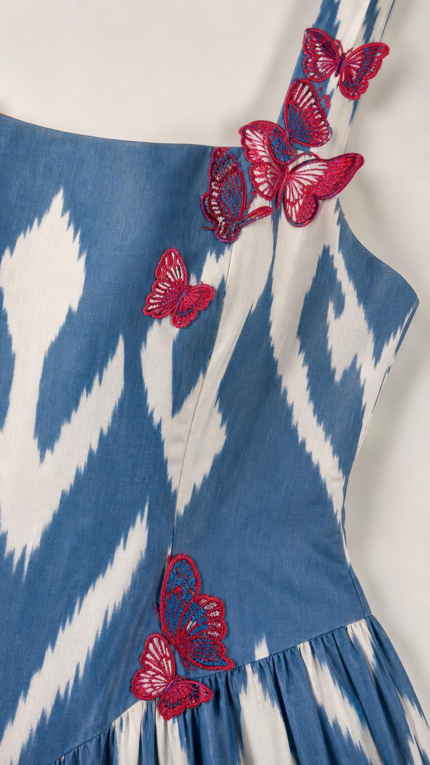 Close-up detail of butterfly embroidery on dress strap and bodice