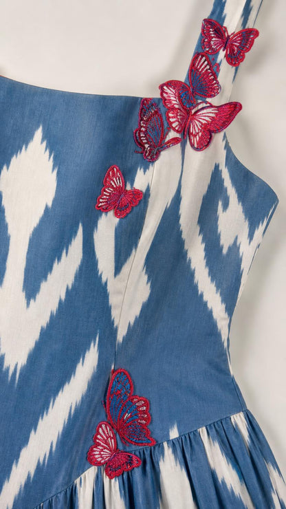 Close-up detail of butterfly embroidery on dress strap and bodice