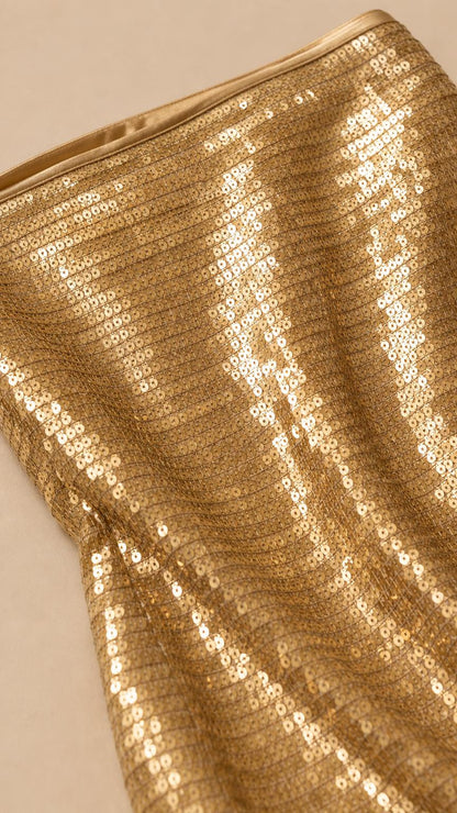 Close-up detail of gold sequin fabric texture