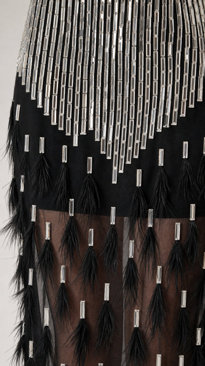Close-up detail of silver crystal beading and black feather trim