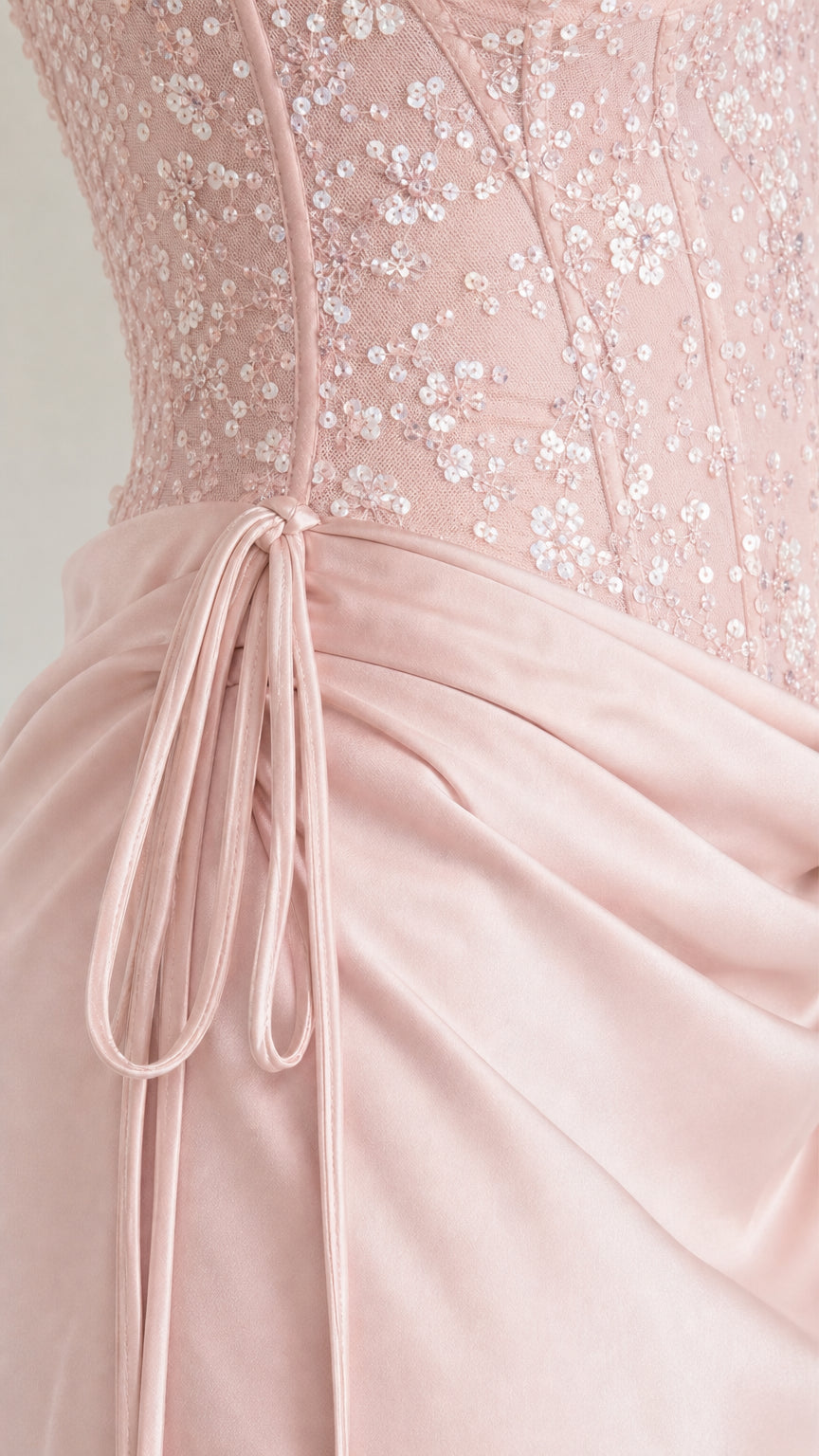 Close-up of pink sequin bodice and draped satin waist