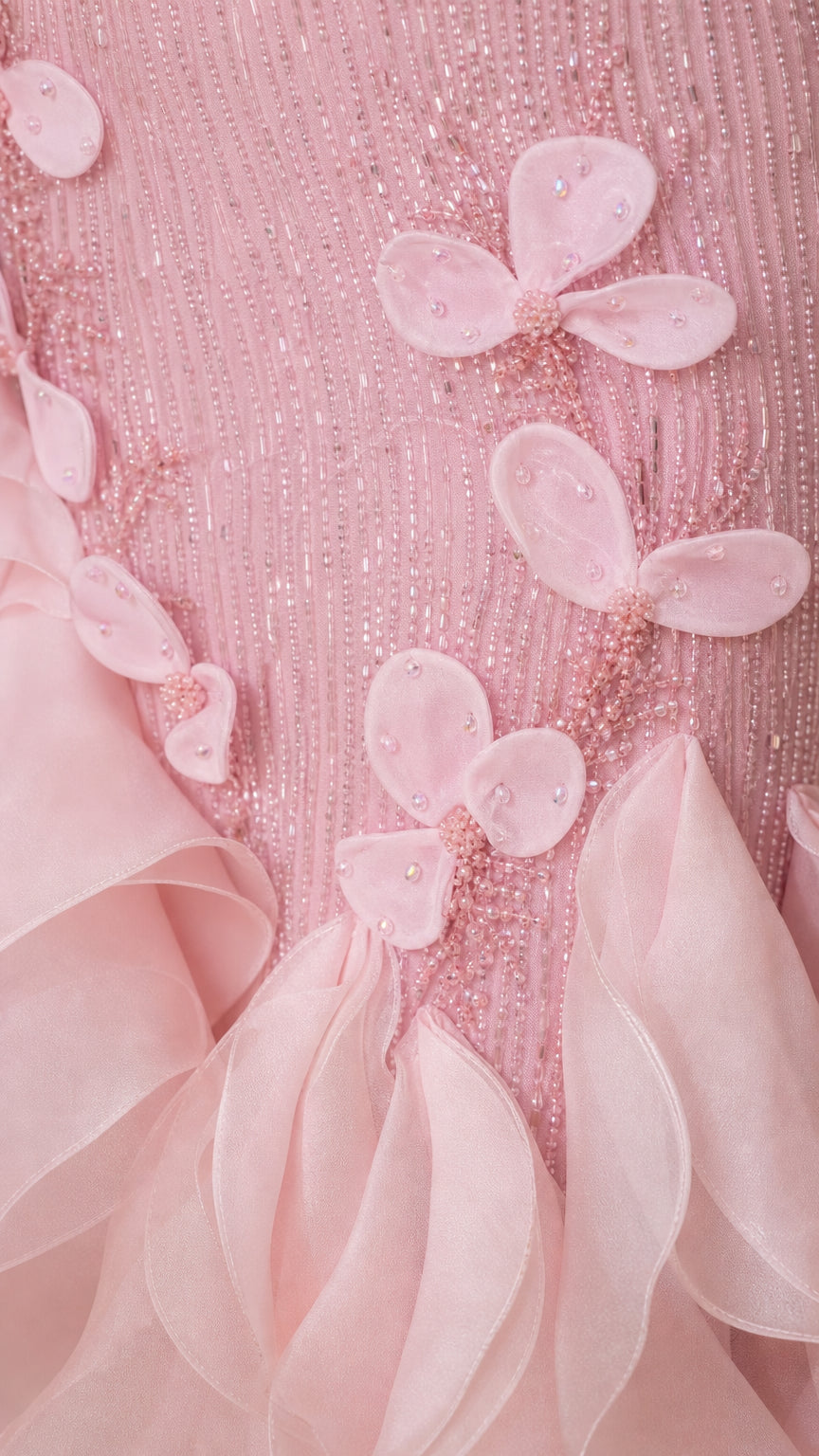 Close-up detail of pink beaded bodice and 3D floral appliqués