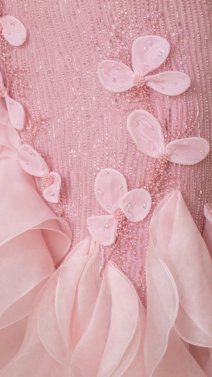 Close-up detail of pink beaded bodice and 3D floral appliqués