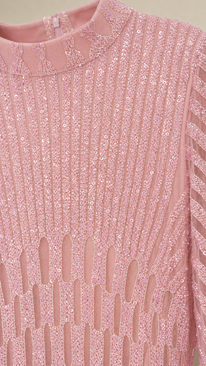 Close-up detail of mock neck and vertical sequin pattern on pink dress