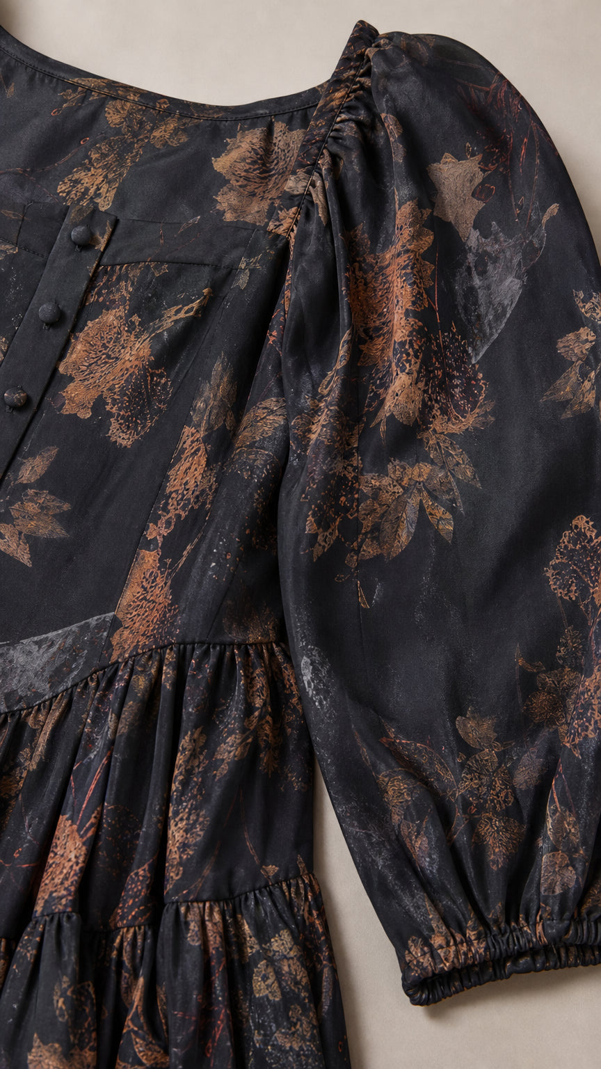 Close up of black floral dress fabric and puff sleeve