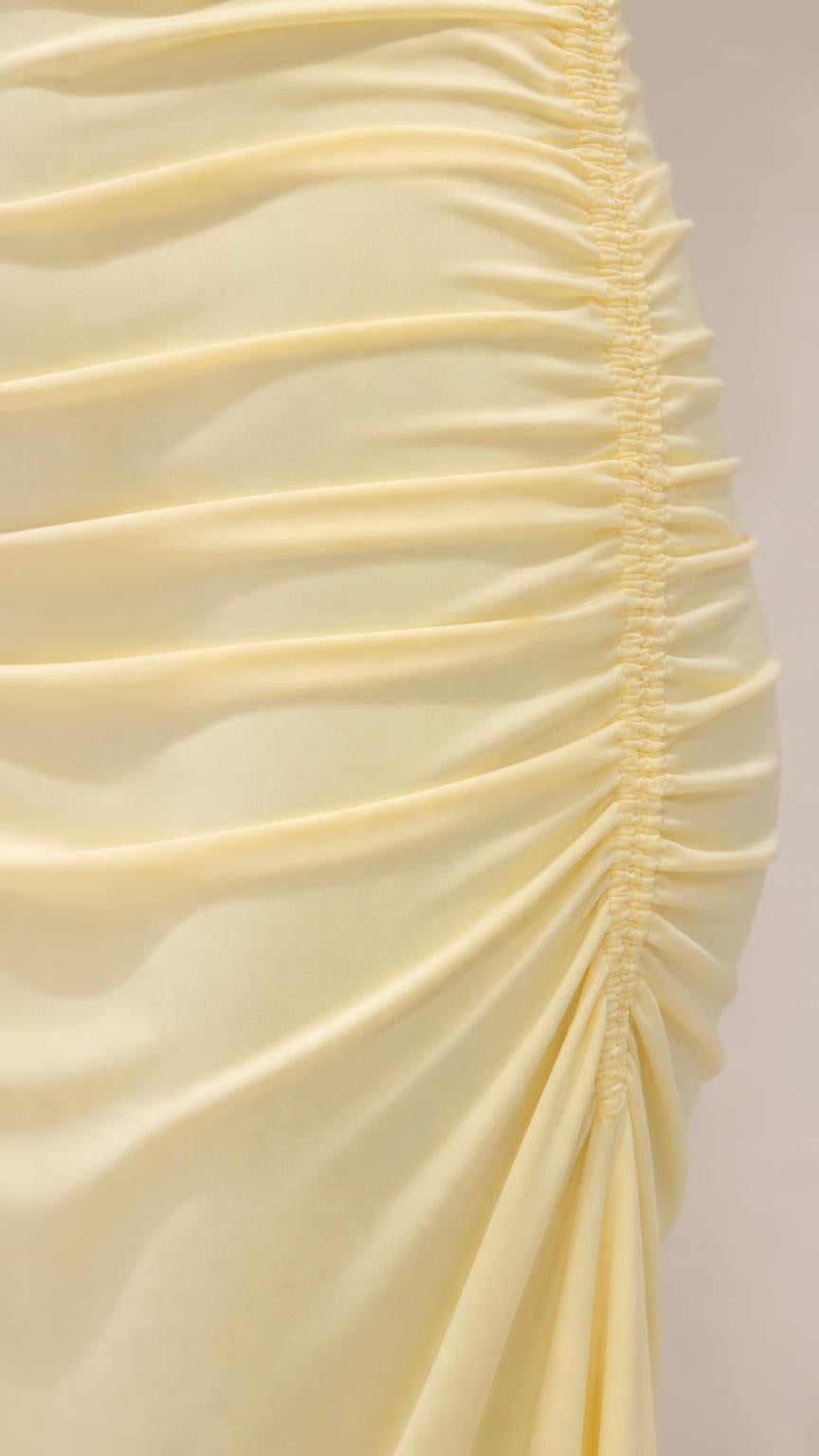 Close-up detail of body ruching on yellow dress
