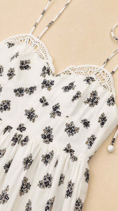 Close-up detail of crochet lace trim and floral print on dress bodice