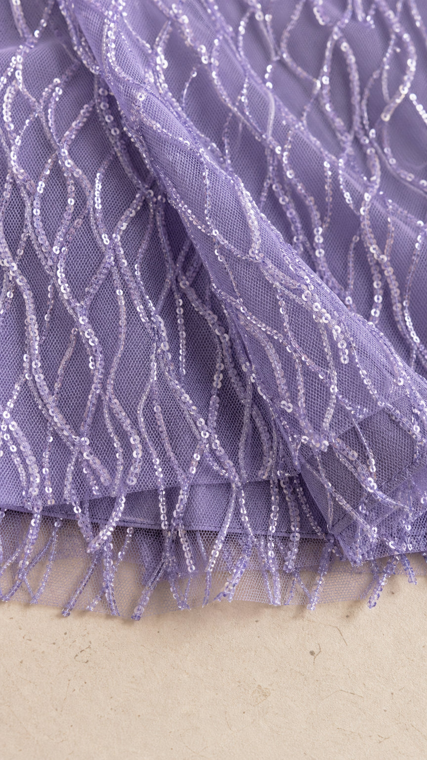 Close-up of lavender mesh fabric with sequin and fringe texture