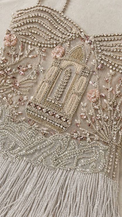 Close-up detail of intricate bodice beadwork and fringe