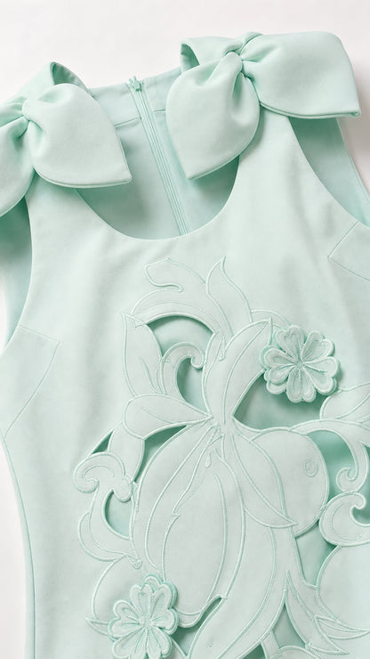 Close up of shoulder bow and floral cutout details in mint