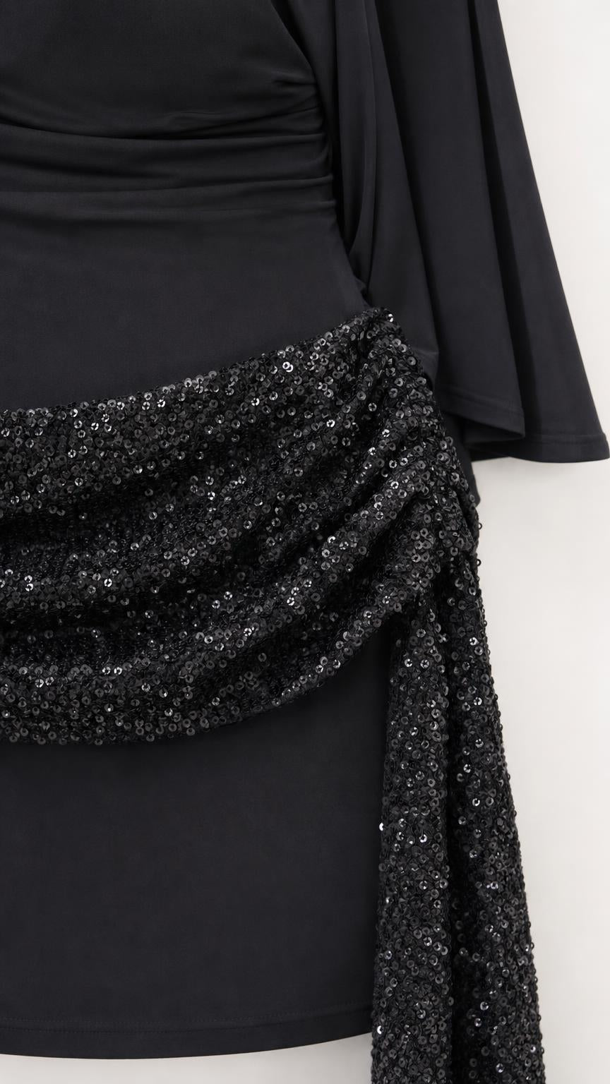 Close-up of sequin embellished waist sash and drape sleeve