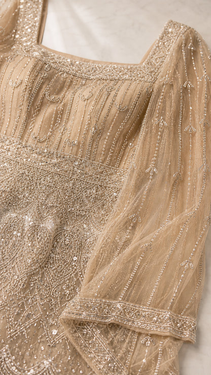 Close-up detail of intricate beadwork, sequins, and square neckline on tulle mesh fabric