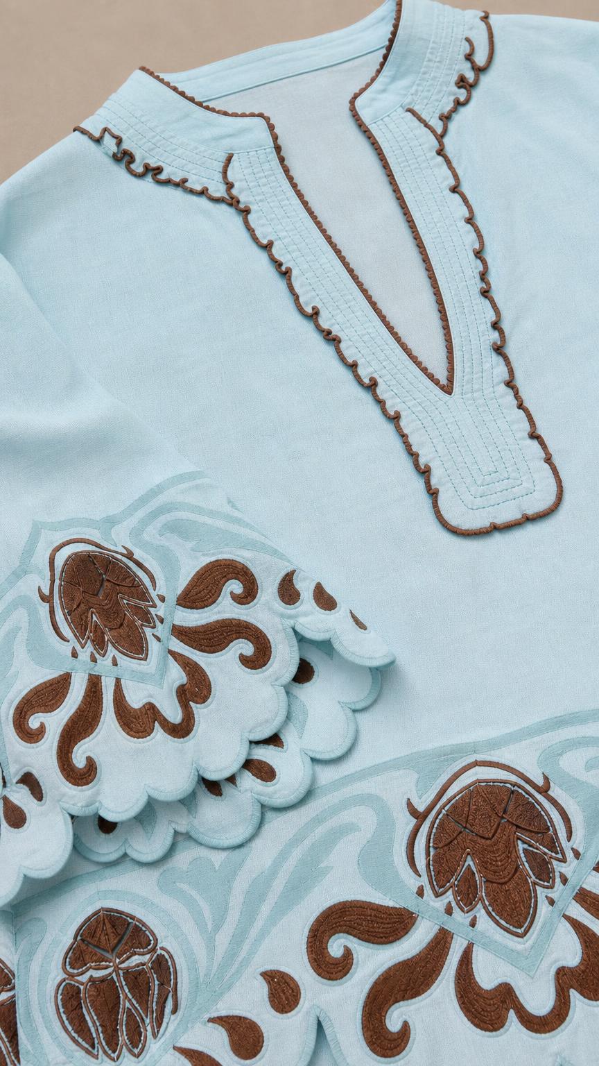 Close-up of embroidery details and scalloped cuffs