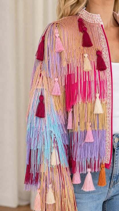 Close-up detail of tiered fringe texture, hanging tassels, and beaded collar