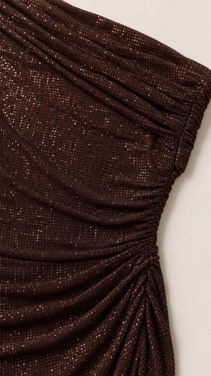 Close-up detail of shimmering fabric texture and side ruching