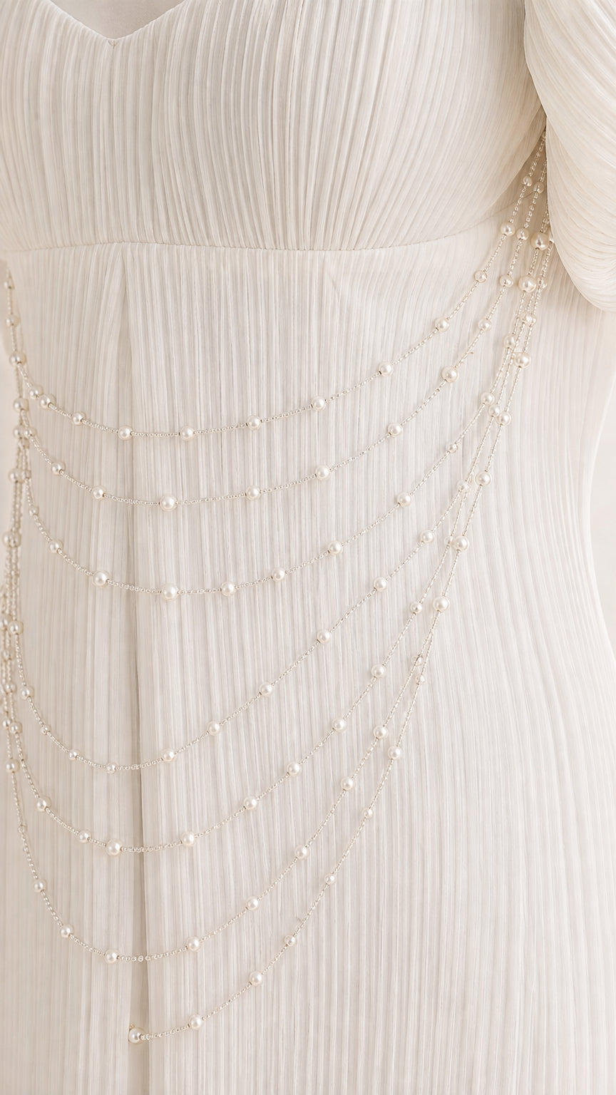 Close up of pearl bead drapes and micro-pleated fabric