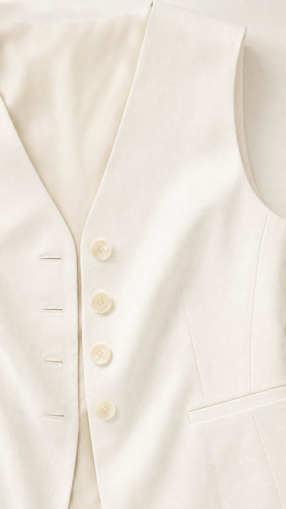Close-up detail of white vest button closure and fabric texture