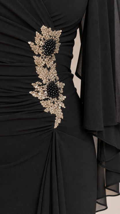 Close-up of sequin floral waist applique on black dress