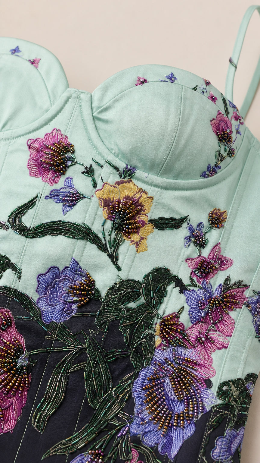 Close-up detail of floral embroidery and beaded bodice