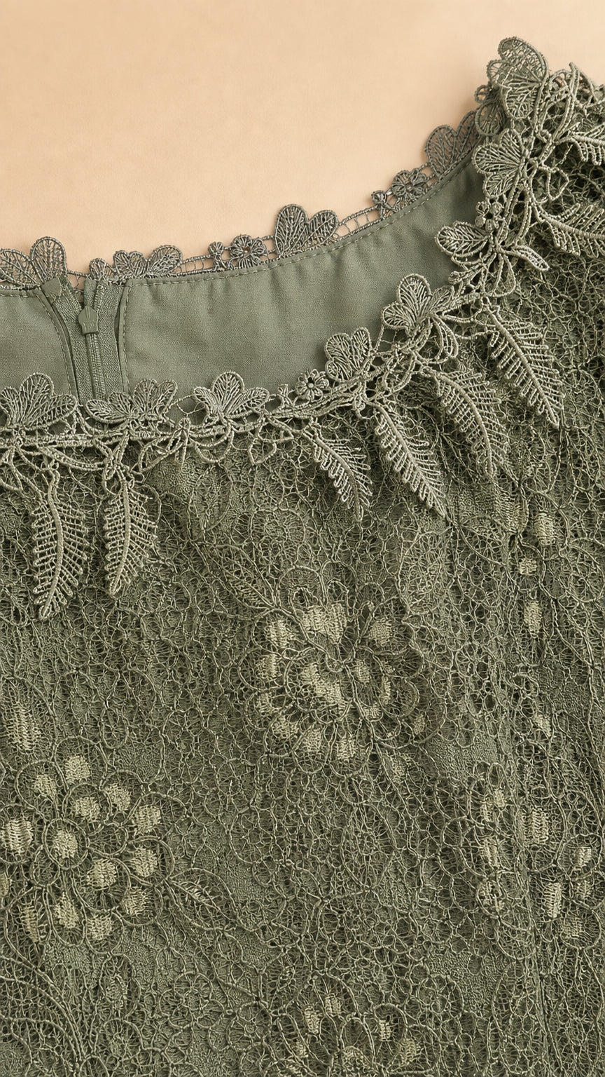 Close-up detail of scalloped lace neckline, zipper, and fine embroidery