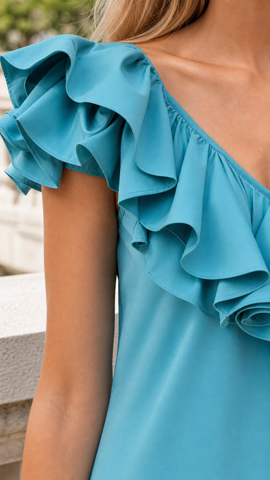 Close-up detail of shoulder ruffles in blue