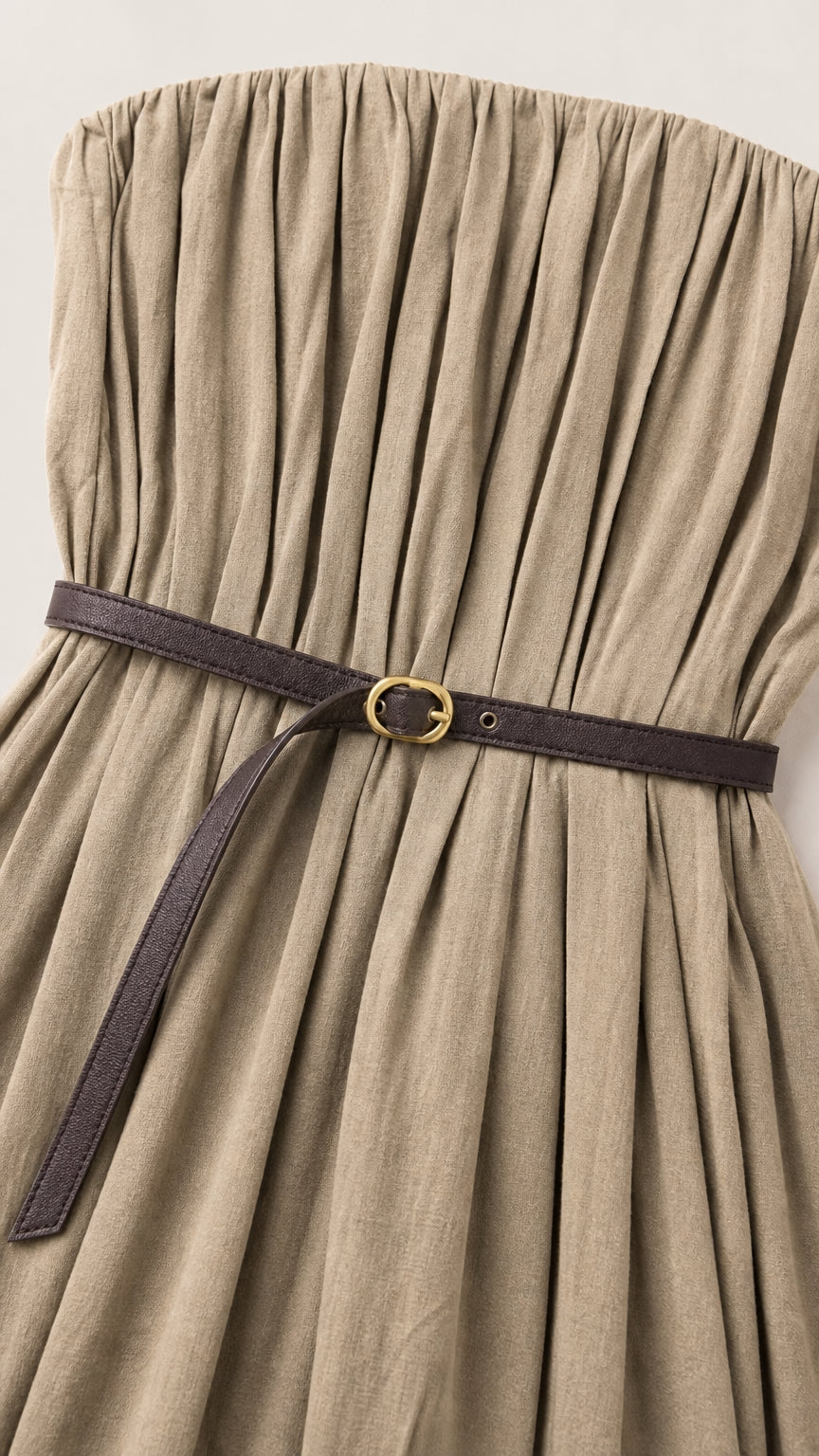 Close-up detail of pleated bodice and belt on khaki maxi dress