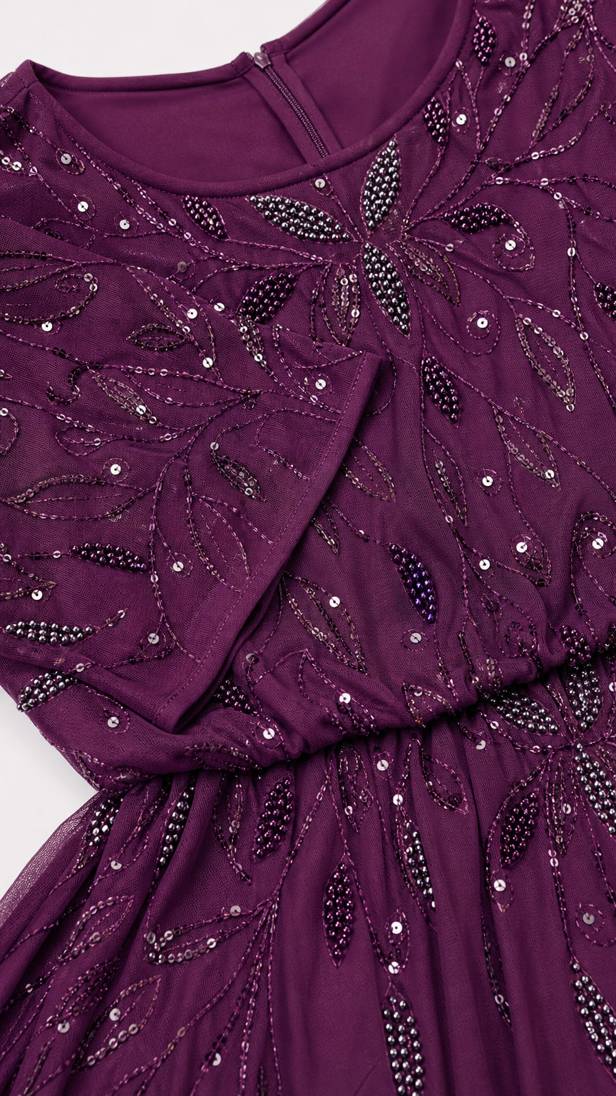 Close-up detail of plum chiffon gown neckline and intricate leaf sequin beadwork