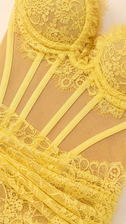 Close-up detail of yellow floral lace and boned corset bodice