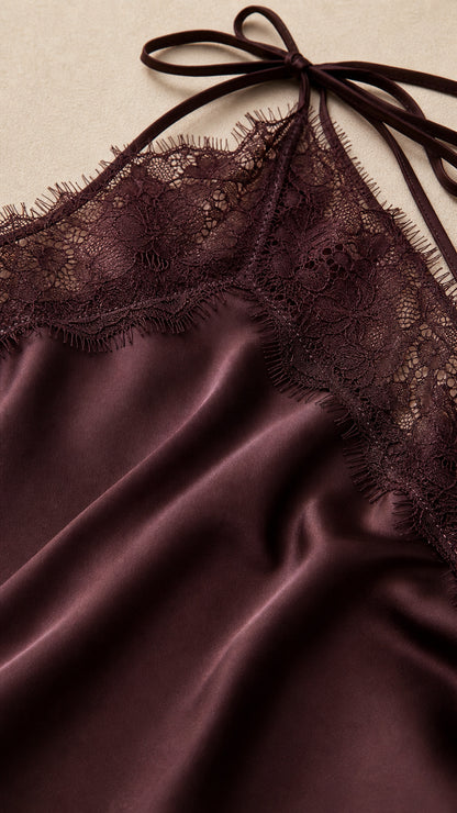Close-up of delicate eyelash lace trim and lustrous Deep Plum satin fabric