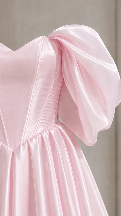 Close-up detail of structured bodice and puff sleeve on pink dress