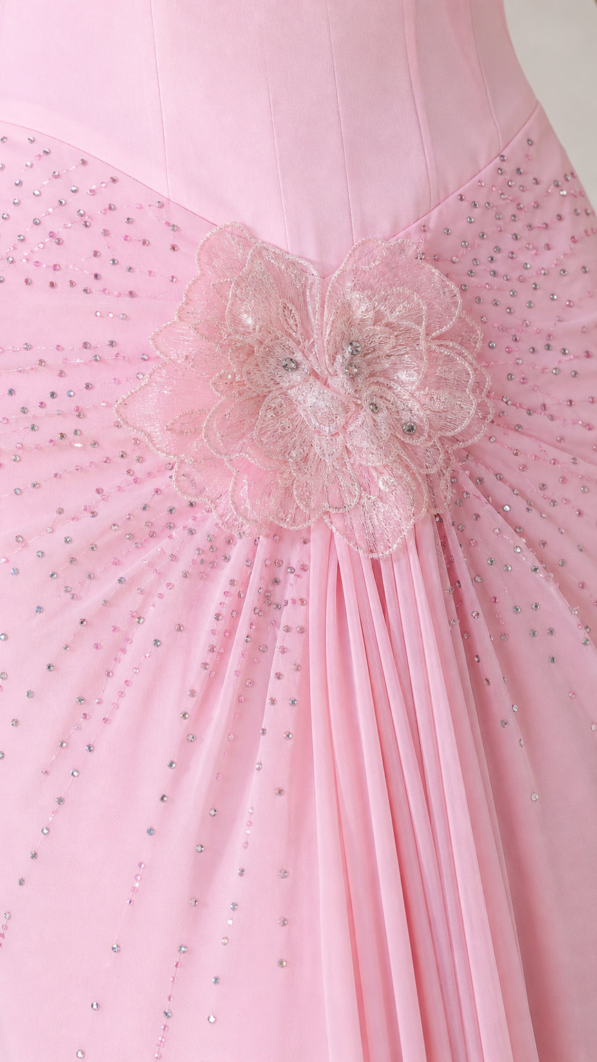 Close-up detail of 3D floral embroidery, sparkling beadwork, and draped fabric on gown hip