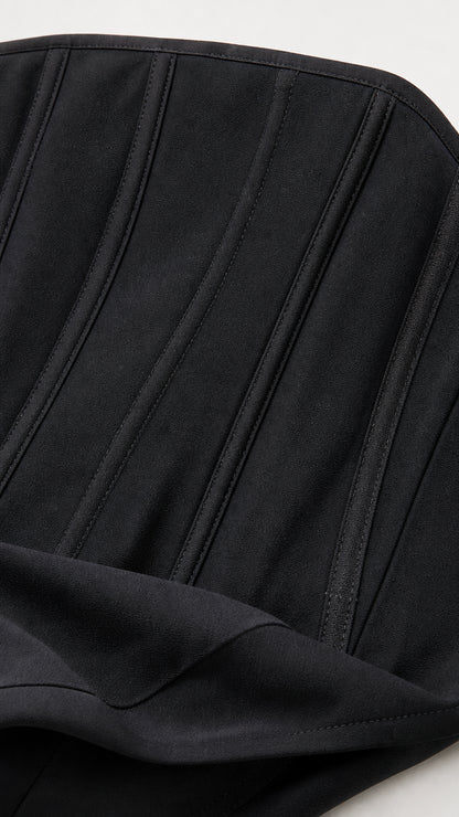 Close-up detail of structured black bodice with vertical seams