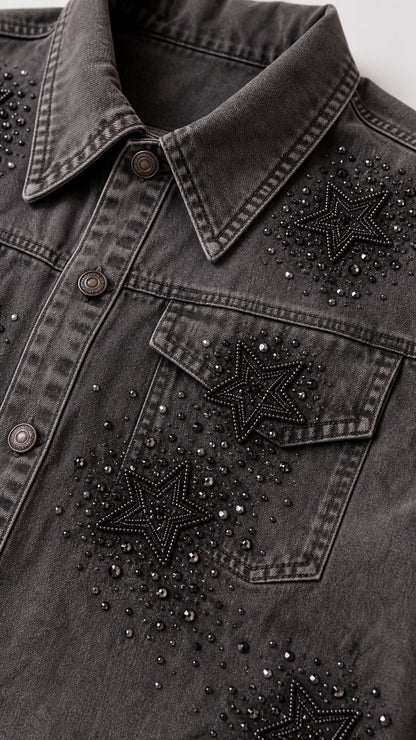 Close-up detail of rhinestone and beaded star embellishments on washed grey denim jacket pocket
