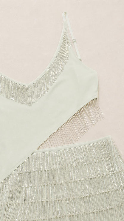 Close-up detail of sage green sequin neckline and fringe skirt