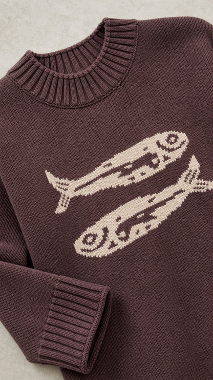 Close-up of Brown knit sweater neckline, ribbed collar, and knit fish graphic