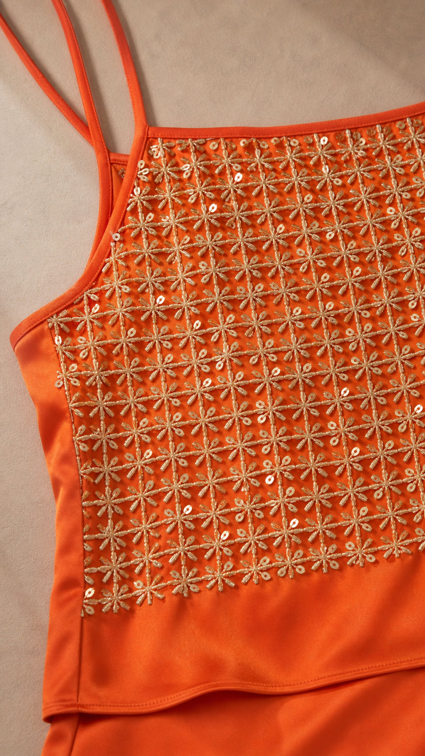 Close-up detail of orange sequin and embroidery on camisole bodice