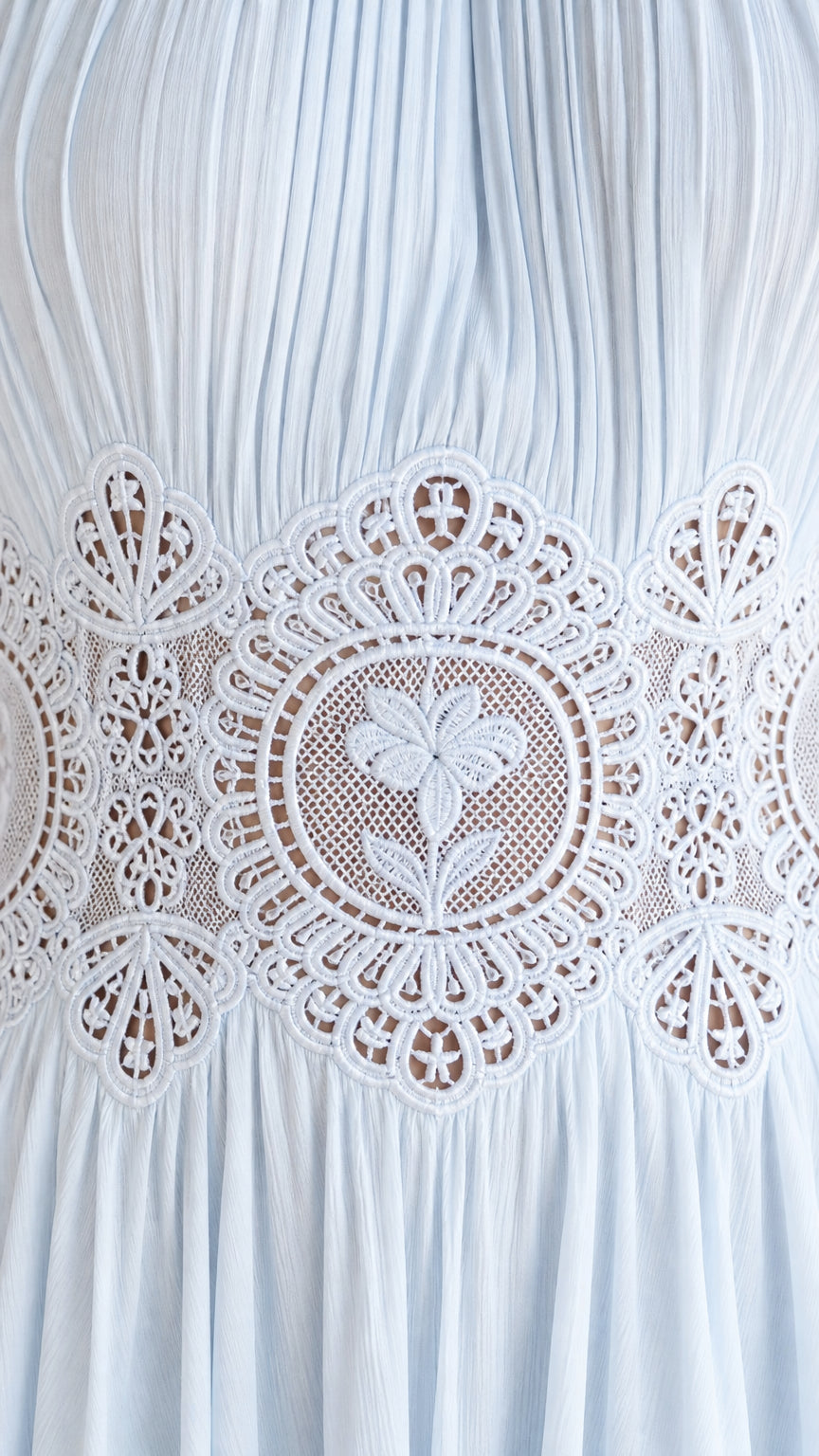 Close-up detail of sheer lace waist panel on the dress