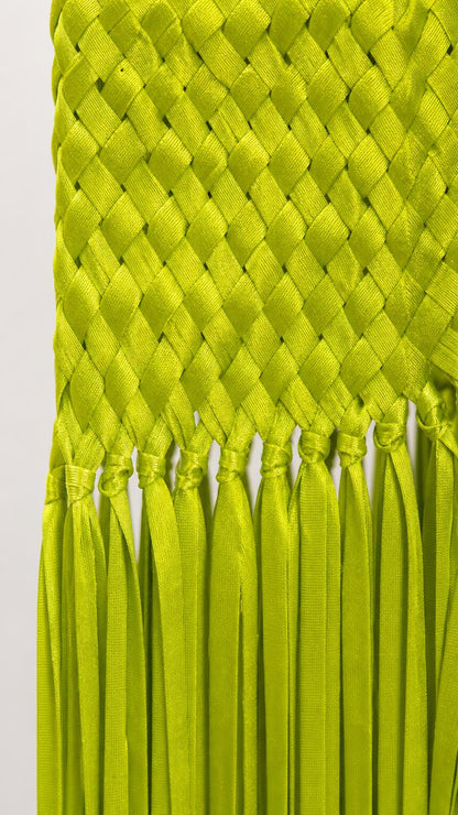 Close-up detail of lime woven texture and fringe hem
