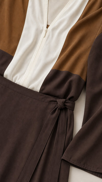 Close-up detail of bodice zipper and tie waist on brown colorblock maxi dress