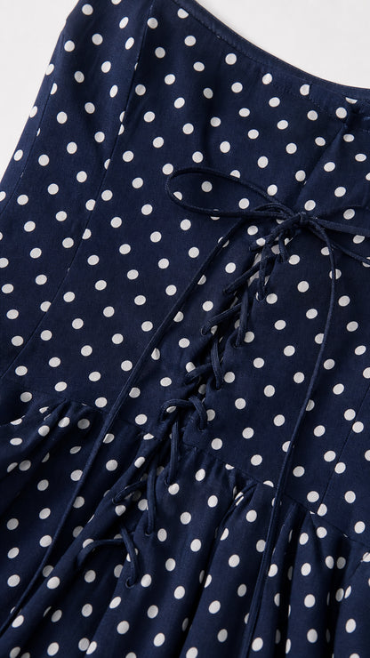Close-up detail of the lace-up back on Navy polka dot dress