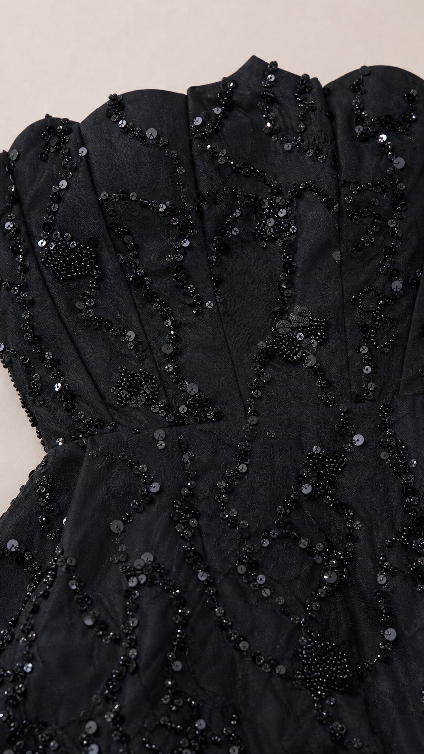 Close-up detail of black corset bodice with intricate sequin and bead embellishments