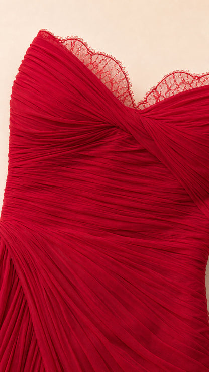 Close-up detail of red sweetheart neckline with lace trim and ruching