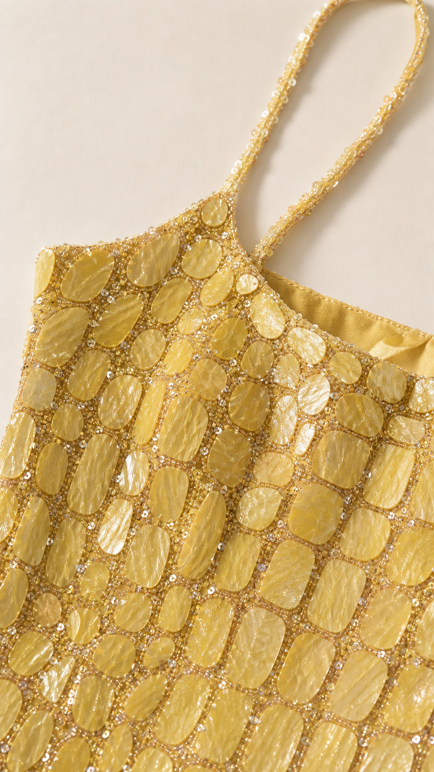 Close-up detail of yellow square sequins and beaded straps